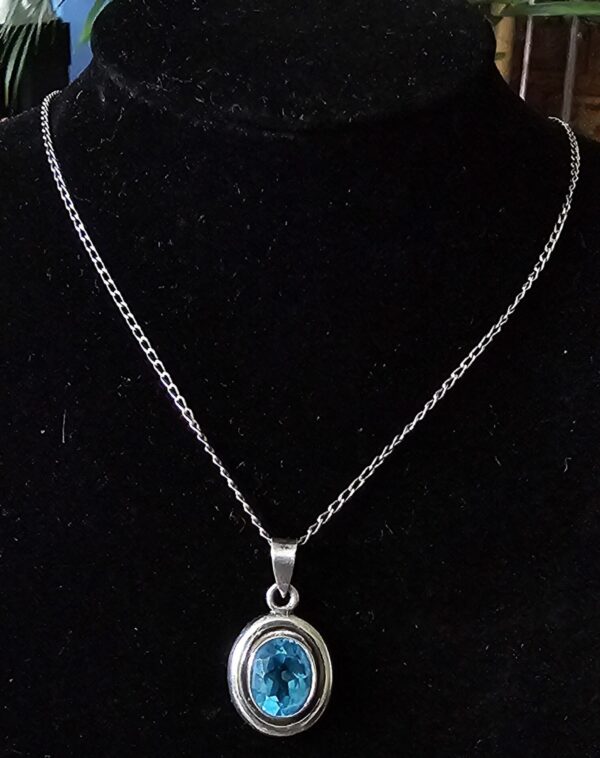 Silver Necklace with oval pendant set with blue stone
