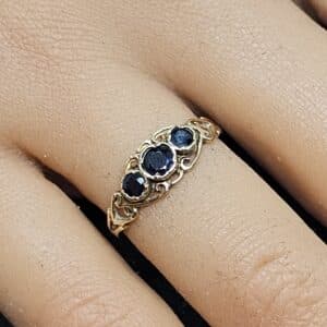 9ct yellow gold three-stone sapphire ring with an ornate, Victorian-style "boat" setting